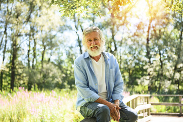 Fototapeta premium Senior man in the nice forest park