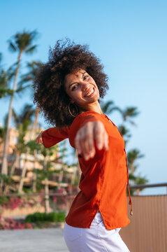 Capturing the expressive joy and vibrant outdoor lifestyle of a young woman celebrating a moment