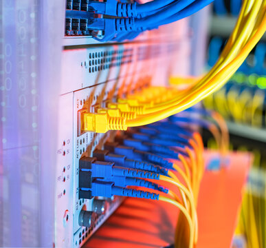 Fiber Optic cables connected to optic ports and UTP, Network cables connected to ethernet ports.