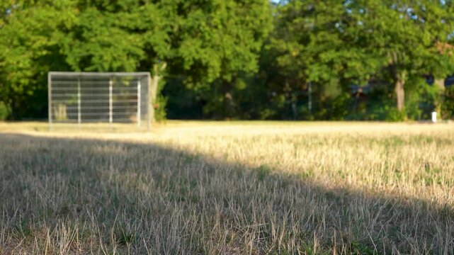 A boy is practicing playing soccer and dribbling the ball