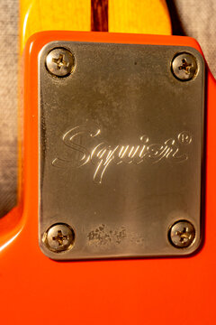 Close up Fender Squier logo, on a Stratocaster guitar.