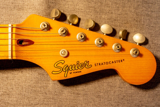 Close up Fender Squier logo, on a Stratocaster guitar.