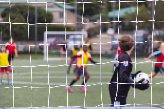 rear view of teenage soccer goalie during match