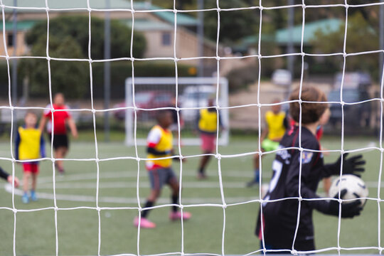 rear view of teenage soccer goalie during match