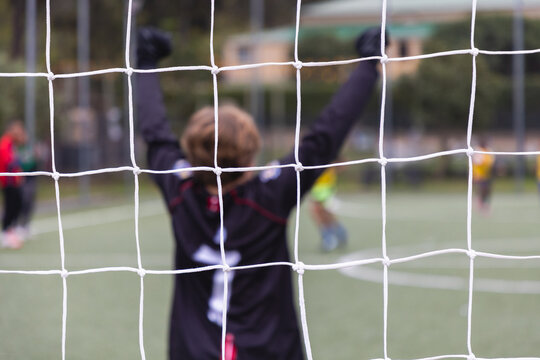 rear view of teenage soccer goalie during match
