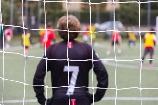 rear view of teenage soccer goalie during match