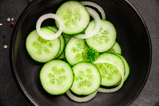 Cucumbers salad fresh vegetable dish delicious appetizer fresh and delicious gourmet food background on the table traditional rustic food top view, copy space keto and paleo diets vegetarian, vegan
