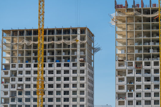 Steel and concrete rise towards the blue sky as new buildings take shape showcasing modern architecture in the heart of a bustling city