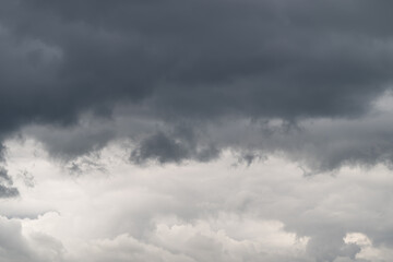 Fototapeta premium Dark clouds gather over a serene landscape hinting at an impending storm