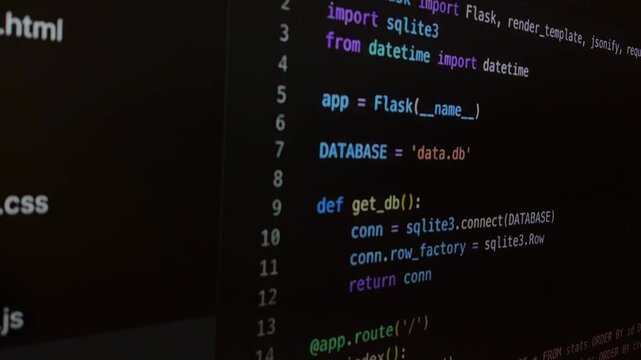 Developer writing python code on a computer screen for a web application using the flask framework and sqlite3 database, with syntax highlighting in a dark mode theme