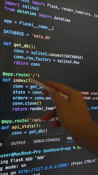 Teacher explaining python programming language script during a coding lesson. A developer is pointing at source code on a screen, teaching web development with a stylus
