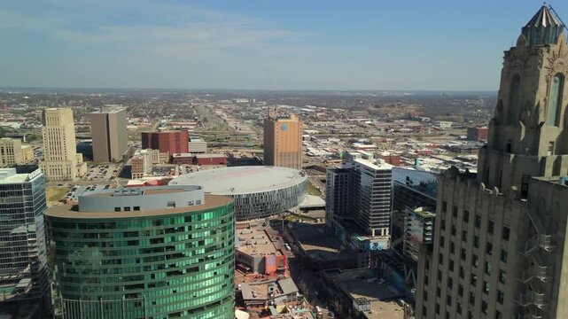 Aerial view of downtown Kansas City with the T-Mobile Center, Power and Light Building, high-rise offices, highways, and urban neighborhoods