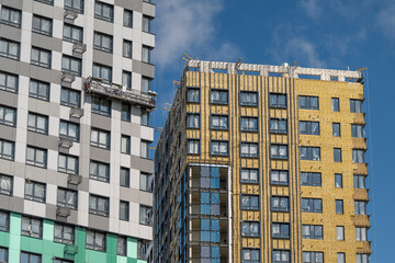 Fototapeta premium Modern skyscrapers showcase unique architectural designs under a clear blue sky in a vibrant urban setting