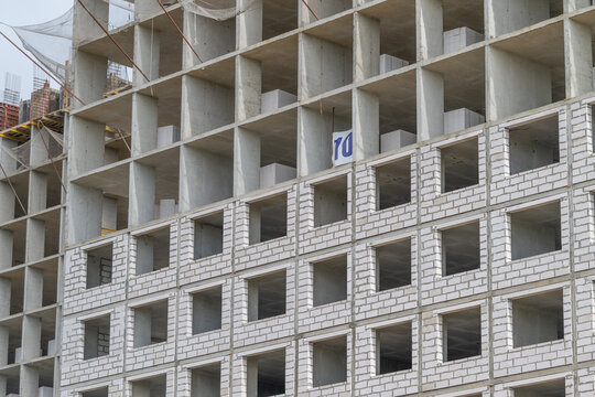 Building under construction showcases modern architecture and design at an urban site in the afternoon sun emphasizing labor and progress in the heart of the city