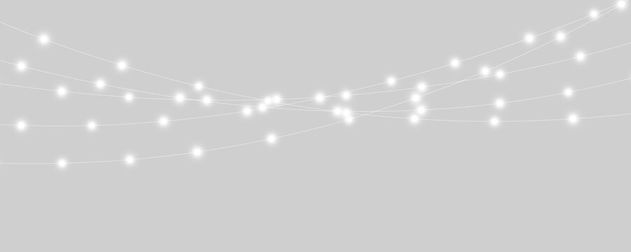 A series of glowing white string lights illuminate against a dark backdrop. The lights are evenly spaced along thin wires that stretch horizontally. This setup creates a soft decorative.