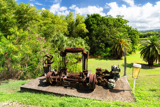 Old rusty industrial sugar mill machinery on concrete base at Trois Rivieres distillery in Sainte-Luce, Martinique, Caribbean France