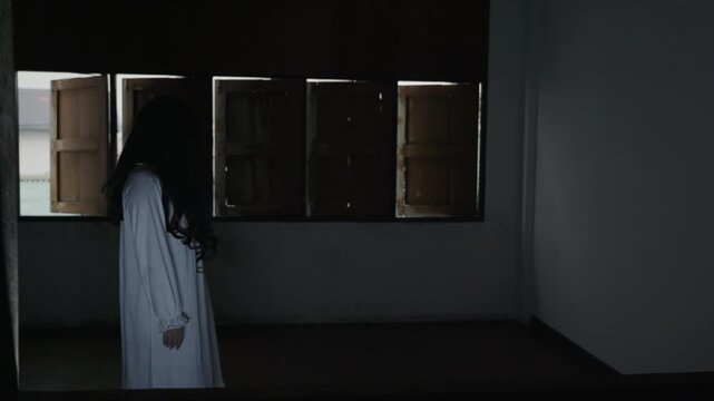 Scary halloween ghost, black devil makeup costume, psychopath dead figure with long hair haunts dark room, creating eerie night and day horror themes for holiday season.