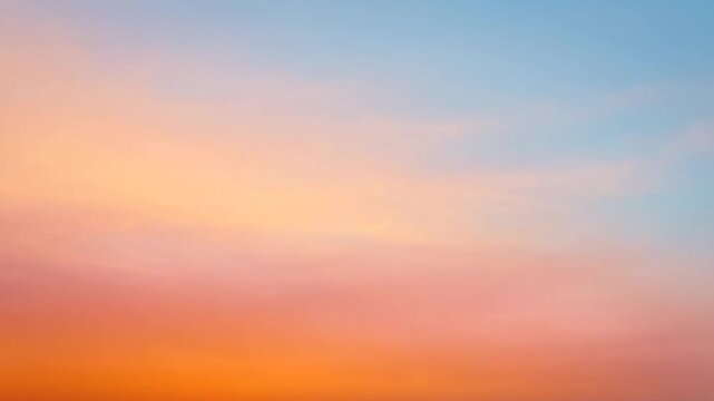 Vibrant sunset sky with warm orange and soft blue gradient clouds