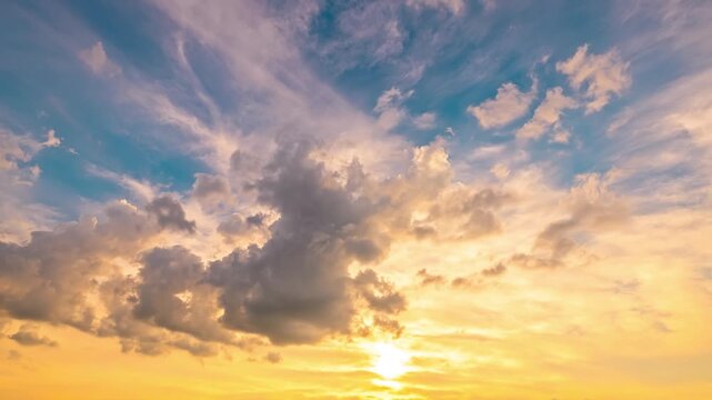 Sunset sky filled with dramatic golden clouds against a deep blue sky