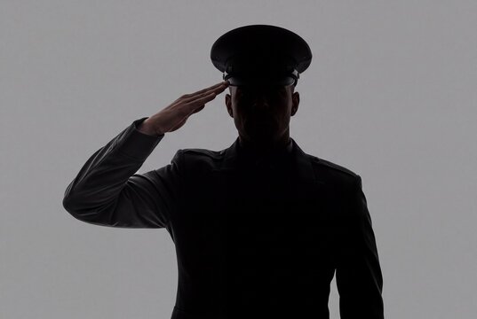 Soldier silhouette performing hand salute in uniform