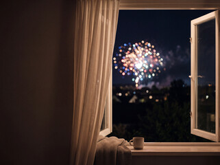 Fototapeta premium Fireworks display seen through open window at night