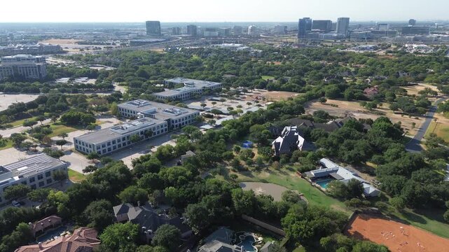 Lowrise commercial office buildings flank private residential properties across Collin County Texas. Wooded estates meet master planned business parks throughout growing Frisco, Texas