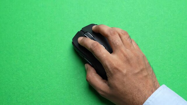 Modern wireless computer mouse moving and clicking on bright green chroma key background for easy compositing