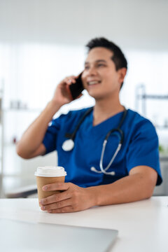 Doctor does phone call with patient to give online consultation sitting at table in clinic.  prescribes medicines for treatment. TeleHealth