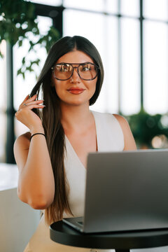 Professional woman working on a laptop in a modern office