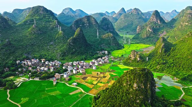 Aerial view of Guilin karst mountains, paddy fields and village in Guangxi, China.