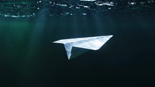 Paper Airplane Gliding Underwater In Dark Shimmering Light
