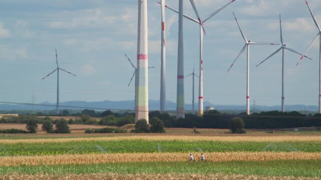 wind turbines in countryside in summer 4K