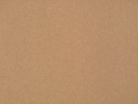 Smooth brown kraft paper texture surface background for design projects. Ideal stock image for eco-friendly packaging, rustic backdrop, crafting material, copy space, and stationery mockup concept