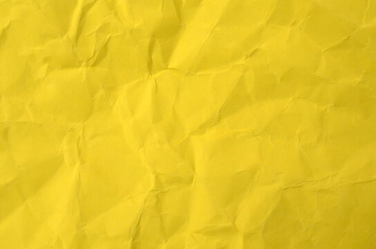 Bright Yellow Crumpled Paper Texture with Copy Space Background