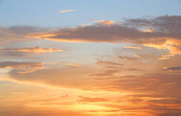 Fototapeta premium Orange and blue sunset sky with clouds