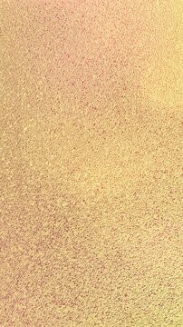 ABSTRACT GOLDEN FROSTED GLASS BACKGROUND WITH WARM SUNLIGHT GLOWING THROUGH TEXTURED CRYSTAL SURFACE, VERTICAL PORTRAIT STOCK FOOTAGE FOR ELEGANT BACKGROUND, LUXURY PATTERN, MOTION DESIGN, AND CREATIV