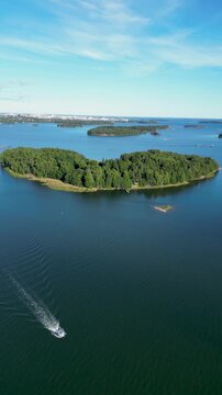 Aerial drone video of Varsasaari in Espoo, Finland, showing the island, surrounding sea, green nature, and peaceful Finnish summer landscape.