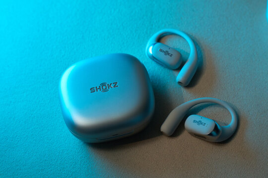 Tyumen, Russia-March 20, 2026: Wireless headphones are displayed next to their case on a smooth surface