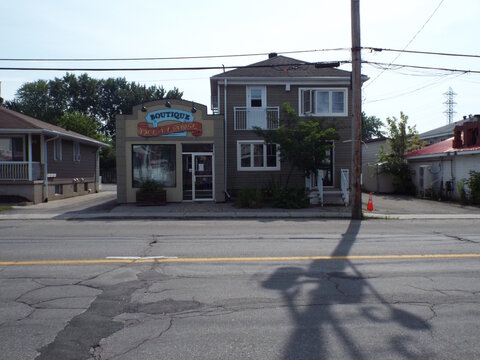 Gatineau, Quebec, Canada &ndash; July 02, 2026: A multi-story building features a storefront with a "BOUTIQUE Deka Danse" sign on its upper facade along a paved street at 378 Rue Main.