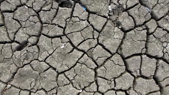 An aerial view of the dried up and cracked earth lake bed exposed by heat wave and drought conditions.