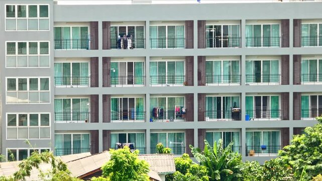 Timelapse of modern building facades with repeating windows, geometric structures, and shifting light, creating a dynamic architectural pattern and urban visual.