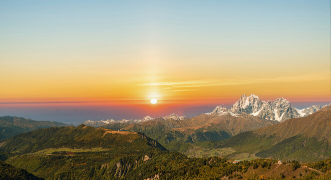 Breathtaking sunset view over Mount Ushba and Caucasus mountain ranges in Adishi, Svaneti, Georgia. Beautiful natural landscape background.
