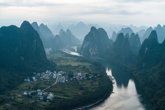 Aerial view of the scenic Li River winding past karst mountains and rural Chinese villages