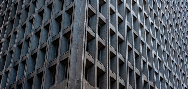 Muted Shades of Gray and Silver on a Monolithic Building.