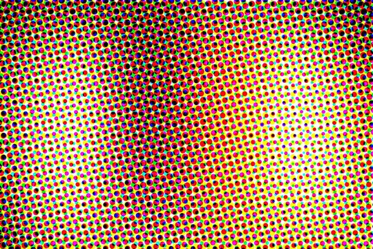 Colorful cmyk halftone dots pattern covering the entire surface with dense distribution for retro print and digital projects