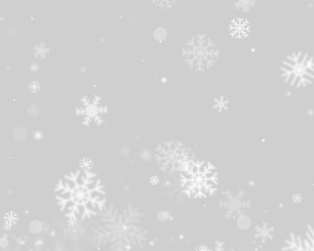 Soft white snowflakes scattered across a deep black background. Various sizes and blurred edges create a sense of gentle falling motion. Ideal for winter holiday themes and seasonal graphic.