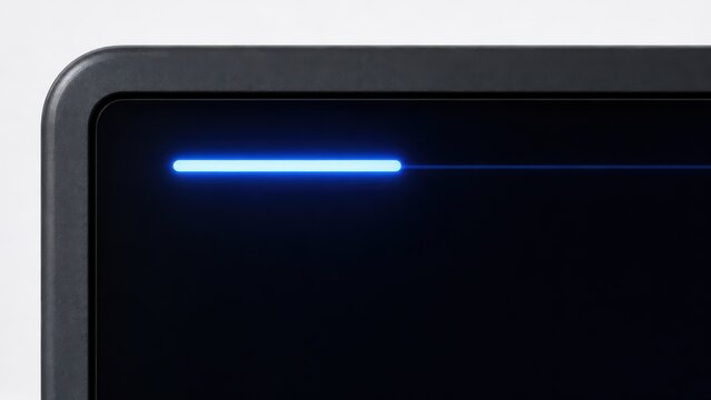 Close up of a dark monitor corner with a blue glowing status line
