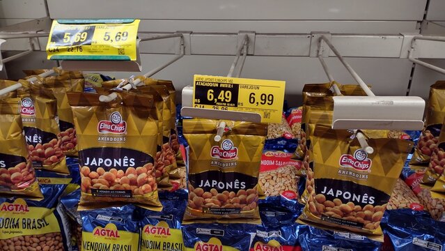 ITABIRA, BRAZIL - AUGUST 26, 2026: Packages of Elma Chips and Agtal peanuts displayed on supermarket shelf with price tags in Itabira, Minas Gerais.