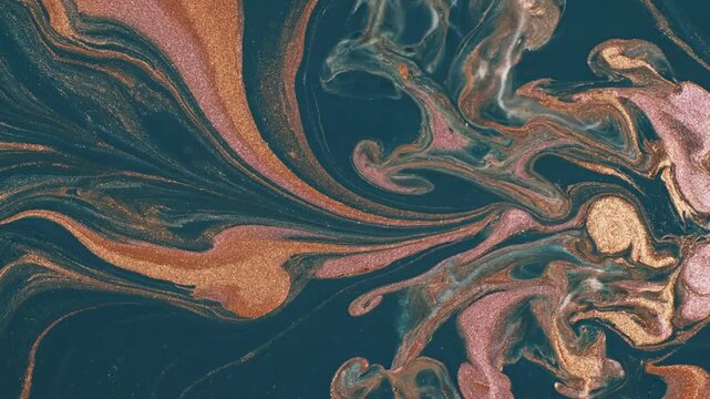 Abstract shimmering gold, rose gold metallic inks swirl in dark liquid, creating an elegant fluid art motion background.