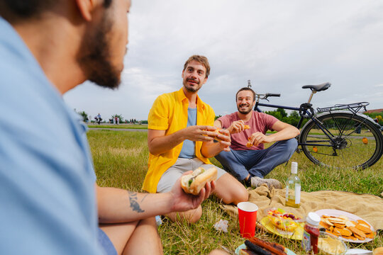 Friends Sharing Food at Park Picnic